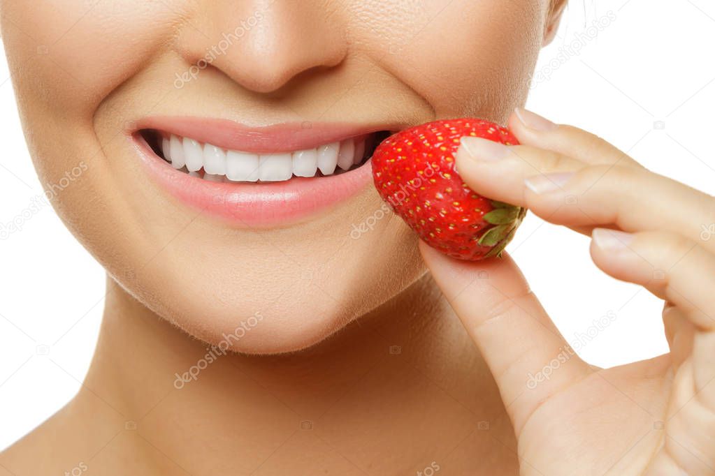 Close up view of female lips and strawberry