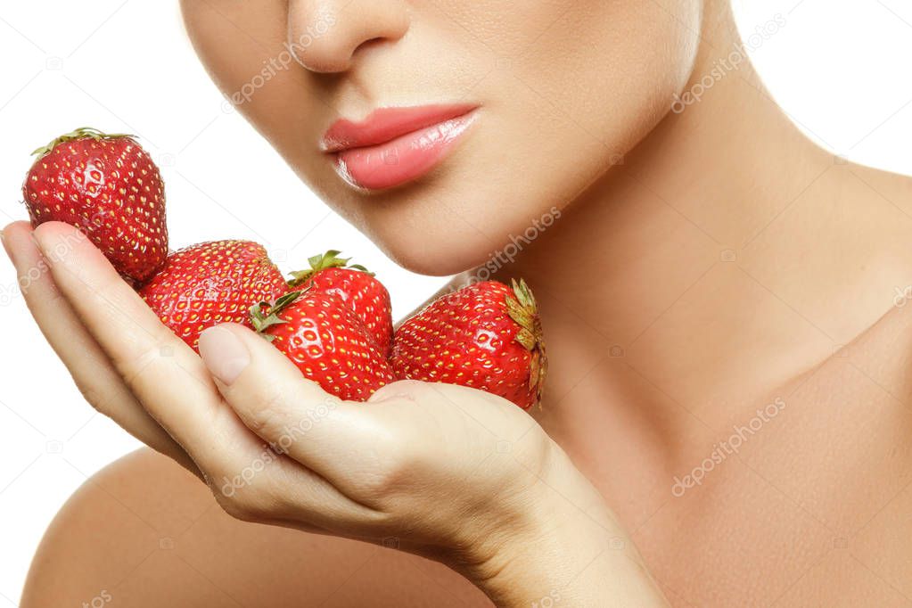 Close up view of female lips and strawberries 
