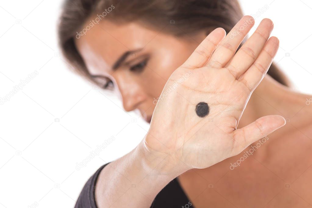Woman with black dot on her palm give signal about domestic violence