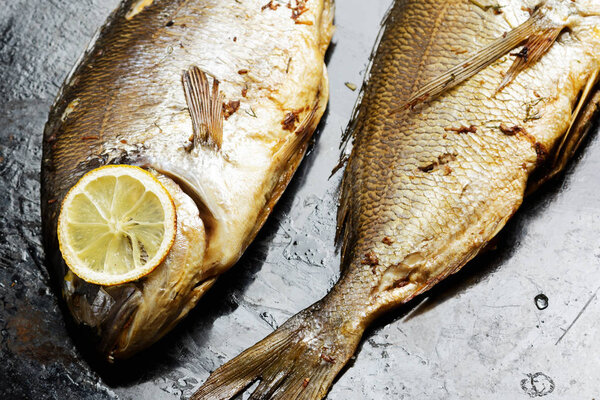 Baked Dorado fish on metal tray