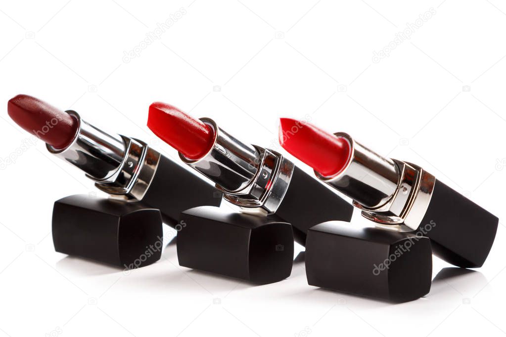 Different kind of red lipsticks on white background