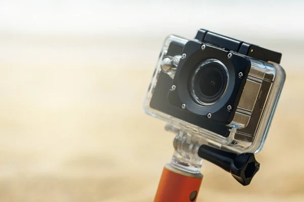 Action camera in waterproof case on the beach