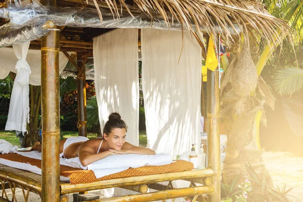 Beautiful woman relaxing after traditional Thai massage