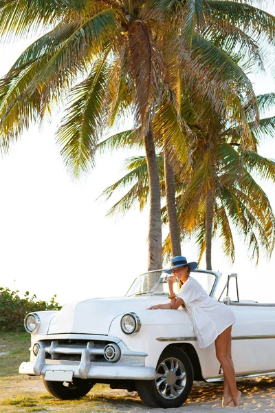 青い帽子と白のレトロなカブリオレ浜辺で美しい女性 — ストック写真