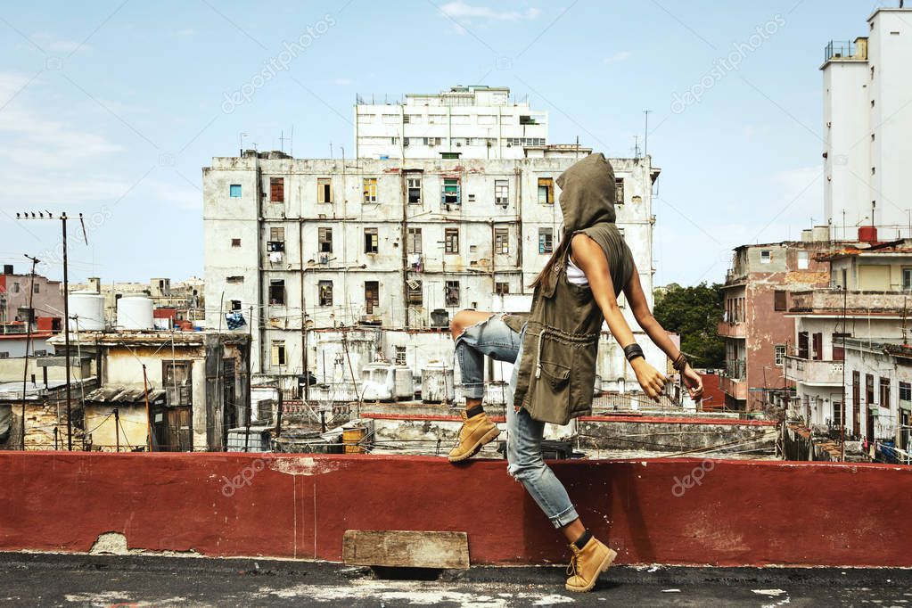 Woman on the roof of old building in poor city