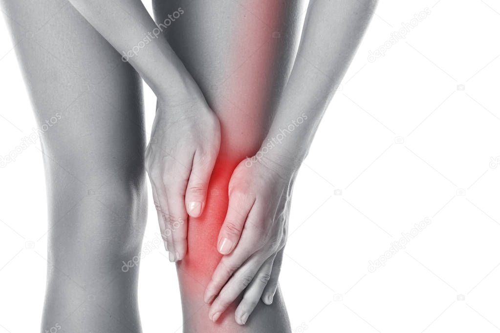 Woman with pain in her knee on white background