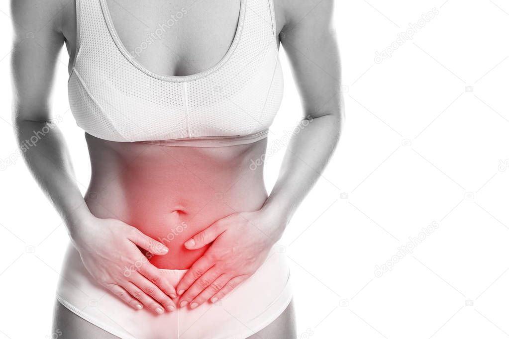 Woman is feeling pain in lower part of her stomach on white background