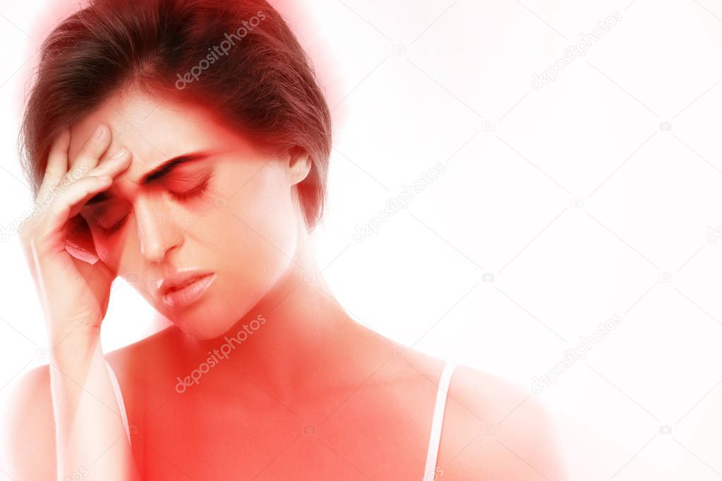 Young woman with a headache on white background