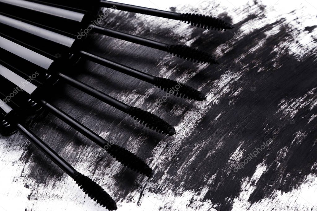 Close up view of brushes and smudged mascara