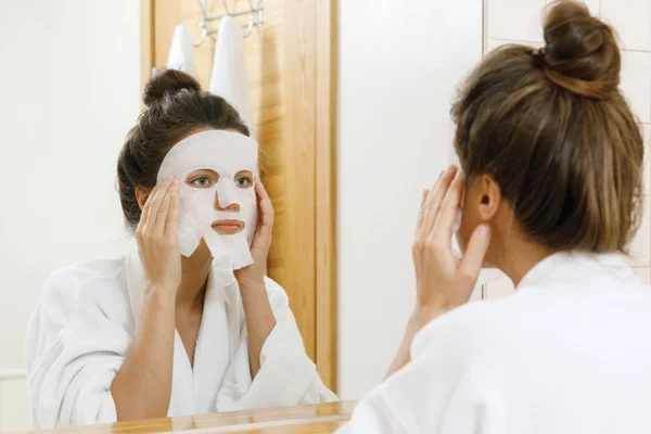 Woman Applying Sheet Mask Her Face Bathroom — Stock Photo, Image