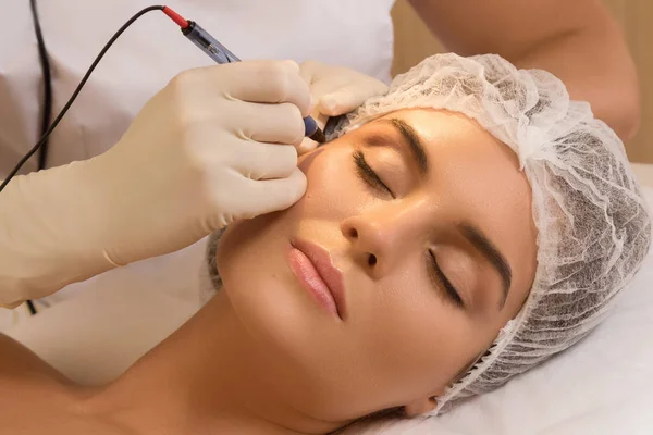 Beautiful woman in cosmetology salon during rejuvenation treatment