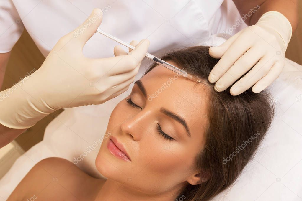 Beautiful woman getting injection for hair growth 