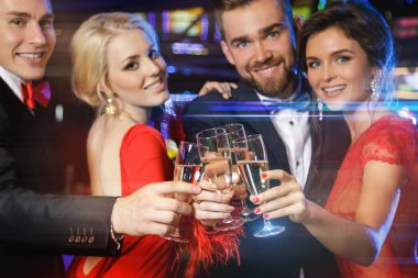 Group of happy people during celebration drinking sparkling wine in casino clipart