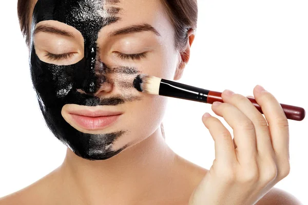 Beautiful Woman Applying Purifying Black Mask Her Face White Background — Stock Photo, Image