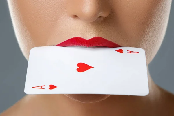 Woman with red lips and ace card in her mouth — Stock Photo, Image