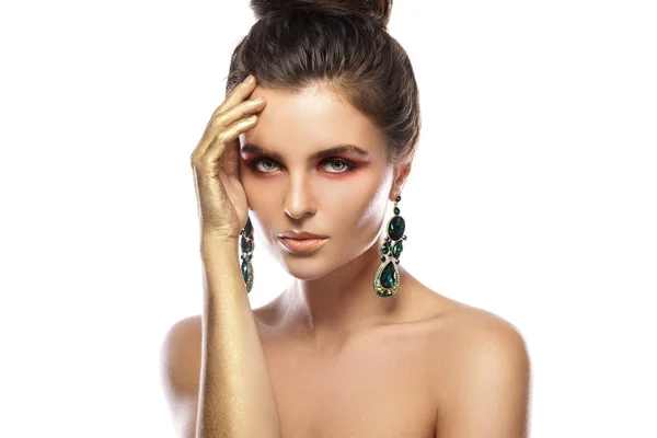 Beautiful woman with a colorful makeup is wearing earrings with — Stock Photo, Image