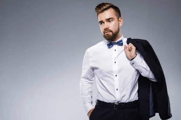 Stylish handsome man wearing a classic suit with bow-tie — Stock Photo, Image