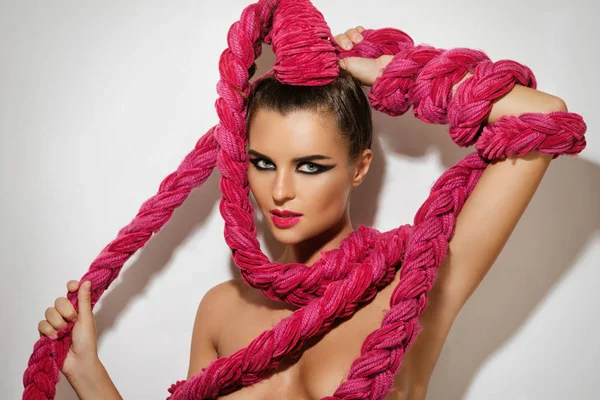 Jonge sexy vrouw met een lange roze vlecht in haar haar — Stockfoto