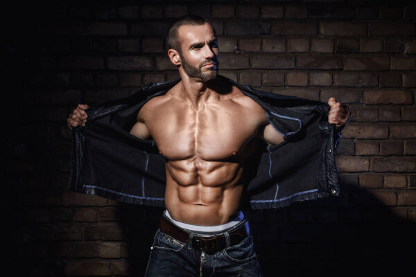 Handsome bodybuilder showing his muscular body