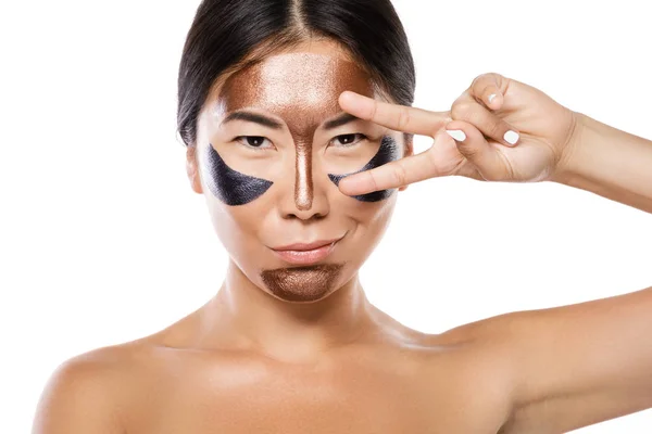 Young asian woman with a purifying peel-off mask on her face — Stock Photo, Image