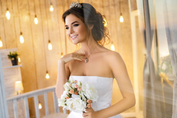 Happy and beautiful bride with bouquet of flowers 