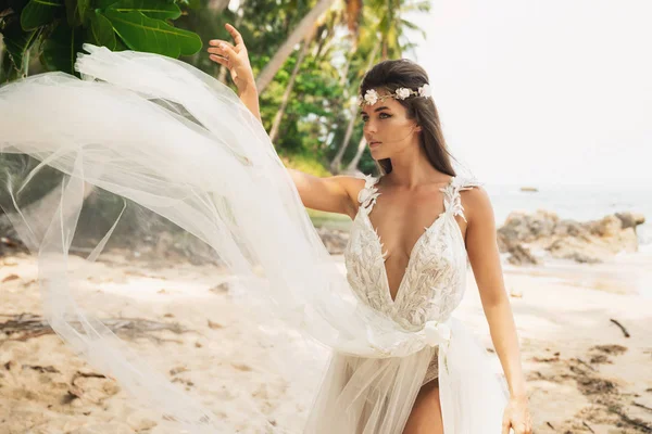 Smyslná nevěsta nosí krásné svatební šaty na tropickém poli je — Stock fotografie