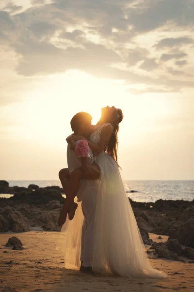 Giovane coppia sposata in abbraccio sta celebrando il loro matrimonio su — Foto Stock