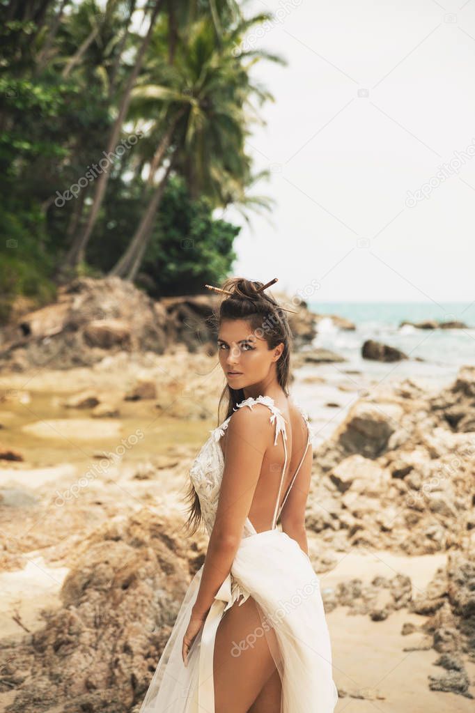 Bride wearing beautiful wedding dress on the tropical beach