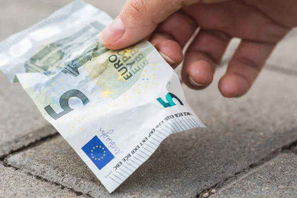 Woman is picking five euro banknote from the ground — Stock Photo, Image