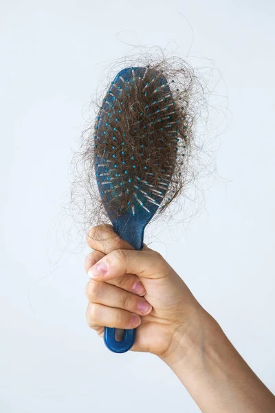 Hairbrush with a lot of female hair — Stock Photo, Image