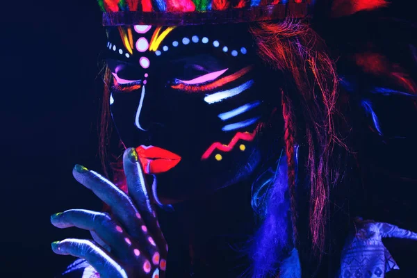 Woman with a neon makeup in ultraviolet light — Stock Photo, Image