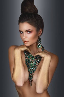 Sexy woman wearing big beautiful necklace with a lot of gems clipart