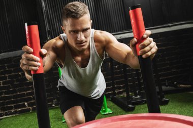 Kızak itme egzersizi sırasında güçlü sporcu