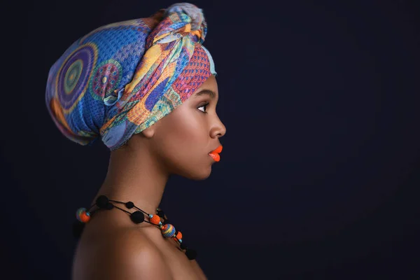 African woman with a colorful shawl on her head — Stock Photo, Image