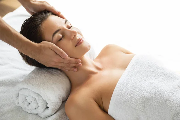 Young and beautiful woman during facial massage session — Stock Photo, Image