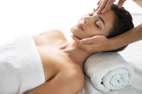 Young and beautiful woman during facial massage session — Stock Photo, Image