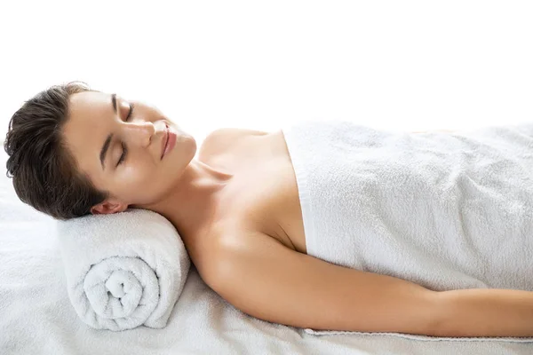 Young and beautiful woman is lying and relaxing after massage se — Stock Photo, Image