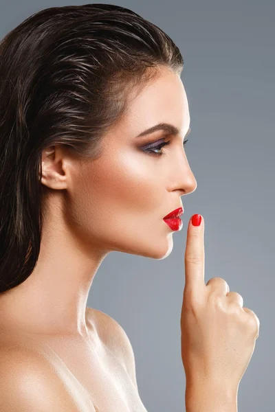 Retrato de una hermosa mujer joven con un lápiz labial rojo y uñas p — Foto de Stock