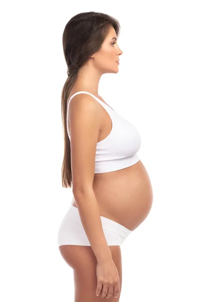 Genç Güzel Hamile Kadın Beyaz Arka Planda Çamaşırı Giyiyor — Stok fotoğraf