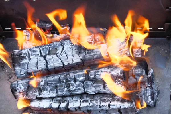 Flammen, brennendes Holz und Rauch aus nächster Nähe. Grillsaison in der Natur eröffnet. — Stockfoto