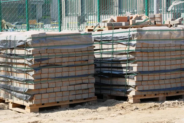 Construction Materials. Pile of gray bricks at construction site. Building materials for construction of building.