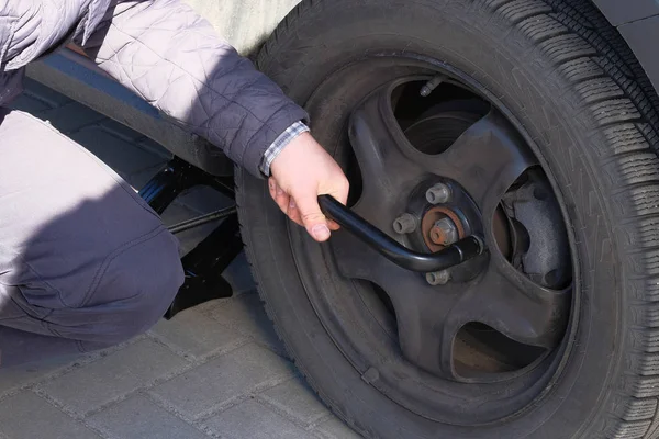 Automobile maintenance concept. Wheel balancing or repair and change car tire. Damaged tyre in car.