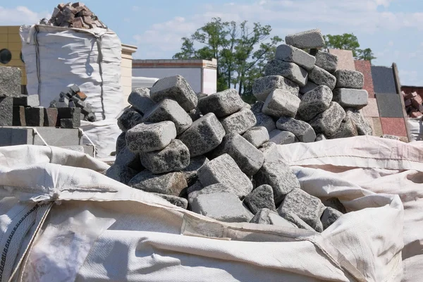 Construction Materials. Building materials for decoration and construction houses. Stacks of gray stones are sold in construction market.