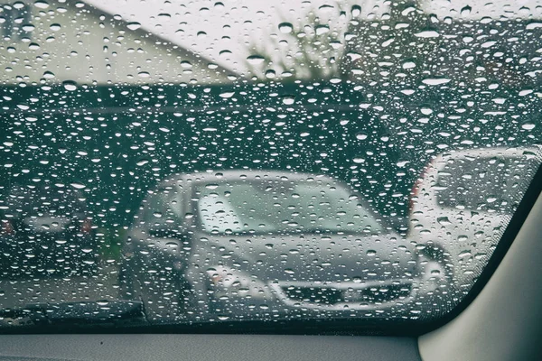 Rain drops on the glass is melancholy. Drops on car window. Inside car when raining.