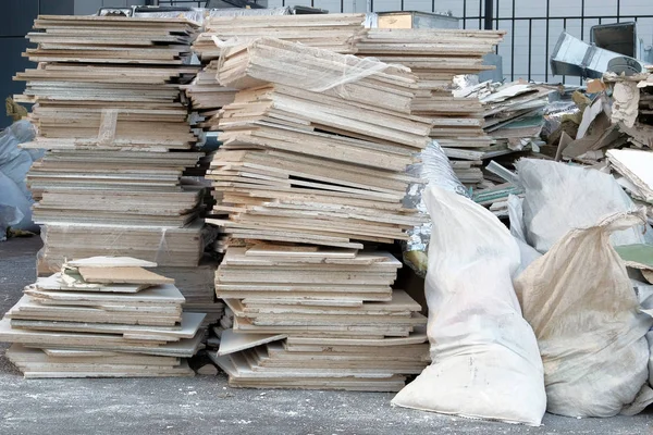 Construction debris in white bags prepared for disposal in a landfill. Removal of debris. Bunch of trash.