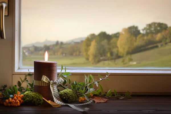 Autumn candle on window season change mood — Stock Photo, Image