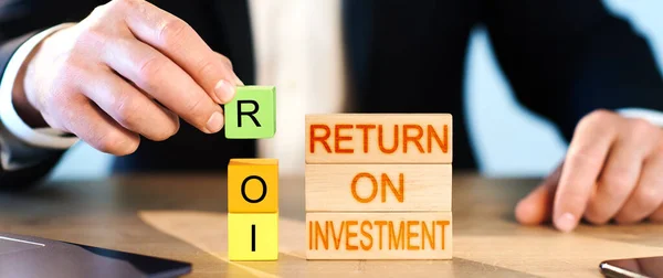 Roi Concept Man Stacks Wooden Blocks Inscription Return Investment — Stock Photo, Image