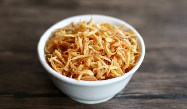 Ahşap arka plan üzerinde kızarmış kırmızı soğan. Tavuk, et veya balık yemeklerinin yanında Tepesi olarak kullanılabilir.