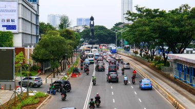 Jakarta, Indonesia - March 6, 2019: Traffic on Jalan Sudirman, near Senayan Roundabout (Bundaran Senayan).