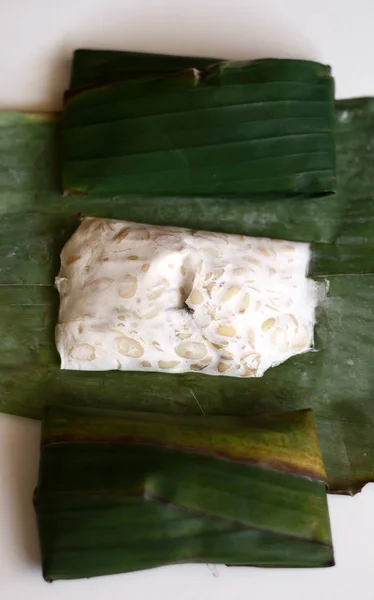 stock image Tempeh on banana leaf, white background. Tempeh is a traditional soy product originating from Indonesia.